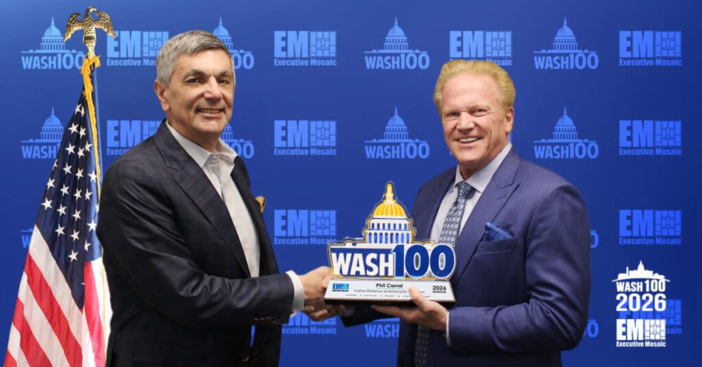 Phil Carrai of Kratos Defense & Security Solutions shakes hands with Executive Mosaic CEO Jim Garrettson as he accepts the 2026 Wash100 Award.