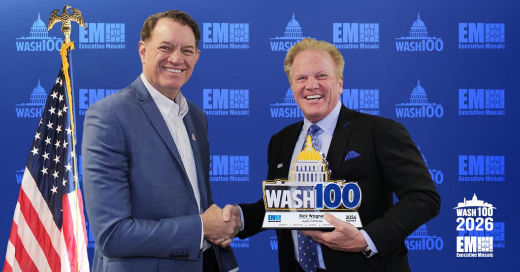 Rick Wagner, CEO of Agile Defense, shakes hands with Executive Mosaic CEO Jim Garrettson as he accepts the 2026 Wash100 Award.