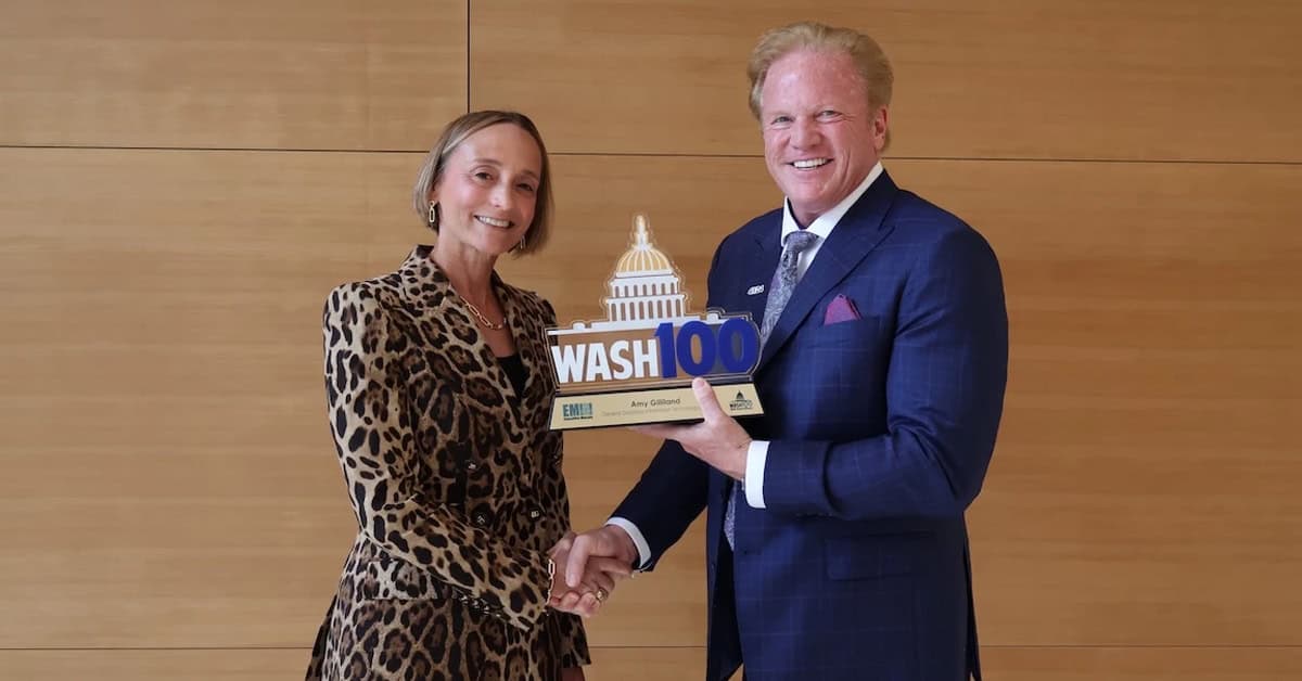 Amy Gilliland and Jim Garrettson. The GDIT president accepted her 2026 Wash100 Award from the Executive Mosaic CEO and award founder in July at GDIT HQ.